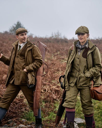 Terragon Brown coloured Harkila Kenmore Shooting Waistcoat on blurry background 