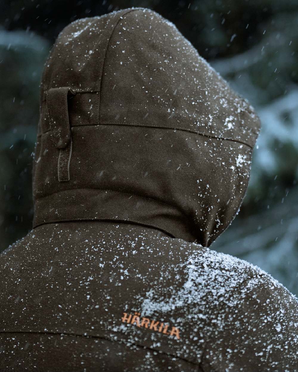 Dark Hunting Green Shadow Brown coloured Harkila Kodiak CleverWool HSP Insulated Jacket on snowy background 