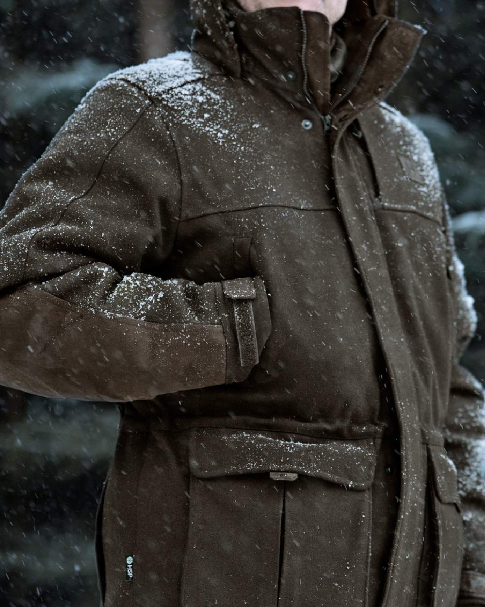 Dark Hunting Green Shadow Brown coloured Harkila Kodiak CleverWool HSP Insulated Jacket on snowy background 