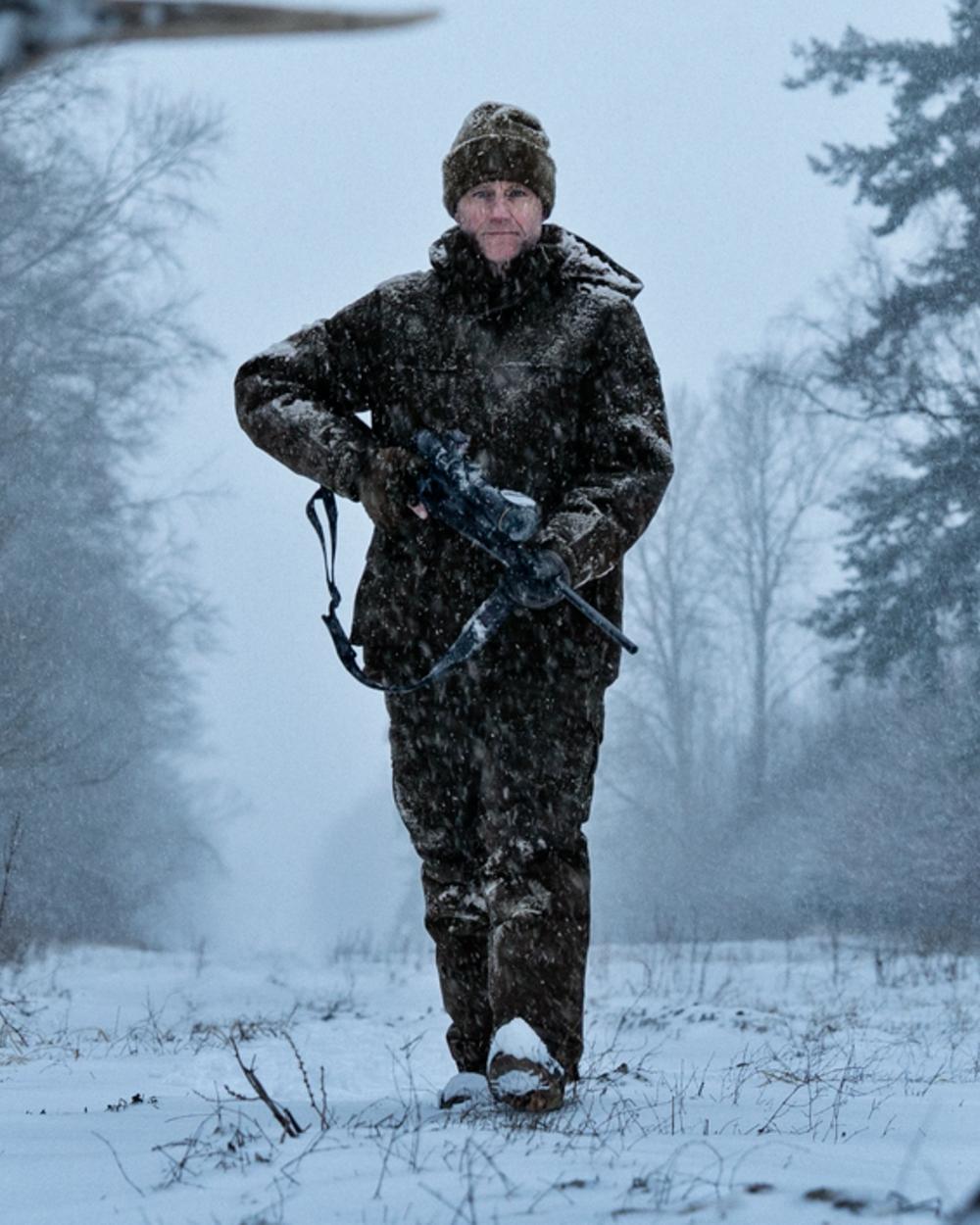 Dark Hunting Green Shadow Brown coloured Harkila Kodiak CleverWool HSP Insulated Trousers on winter background 
