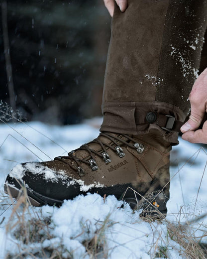 Dark Hunting Green Shadow Brown coloured Harkila Kodiak CleverWool HSP Insulated Trousers on winter background 