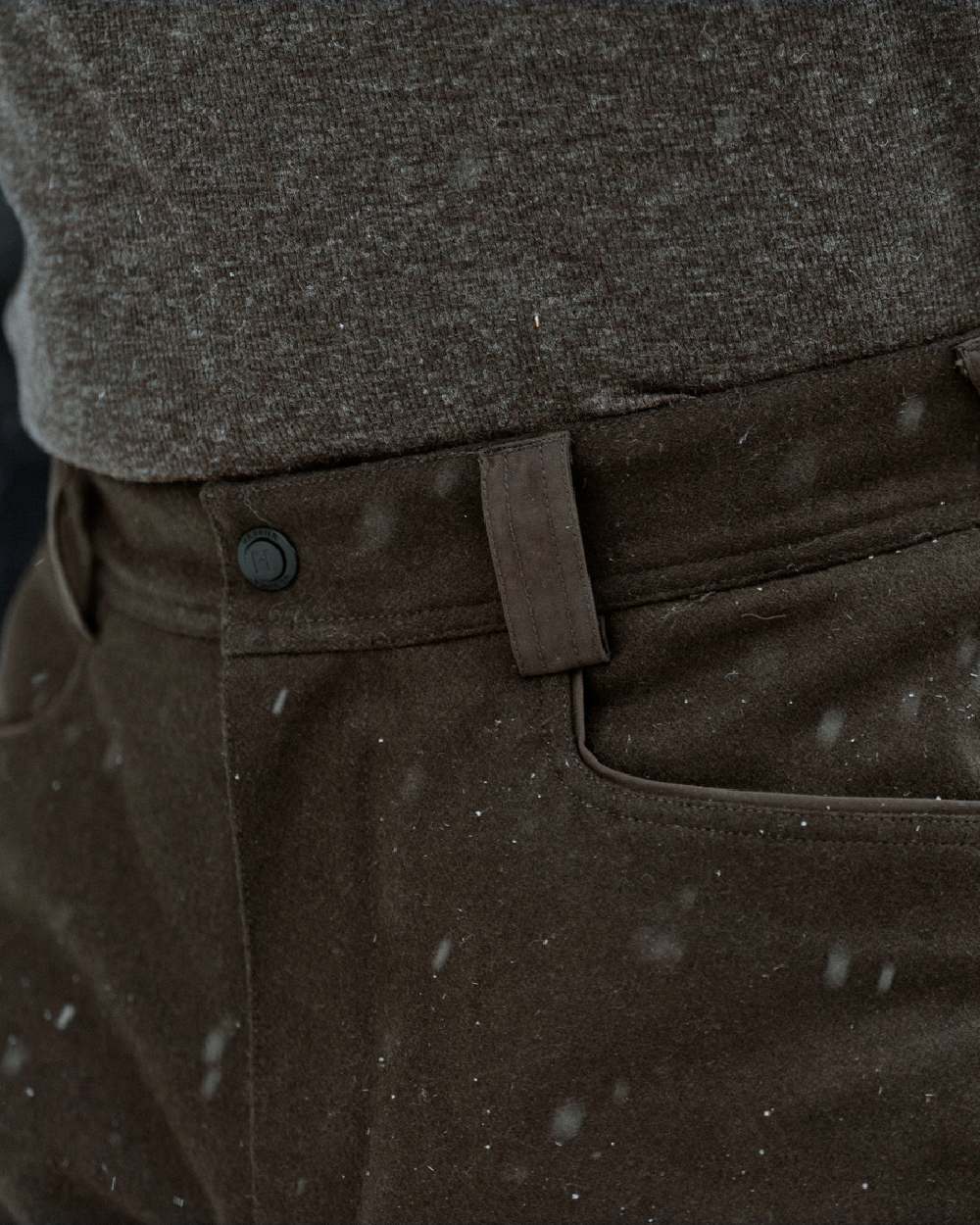 Dark Hunting Green Shadow Brown coloured Harkila Kodiak CleverWool HSP Insulated Trousers on winter background 