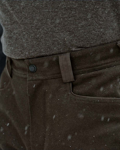 Dark Hunting Green Shadow Brown coloured Harkila Kodiak CleverWool HSP Insulated Trousers on winter background 