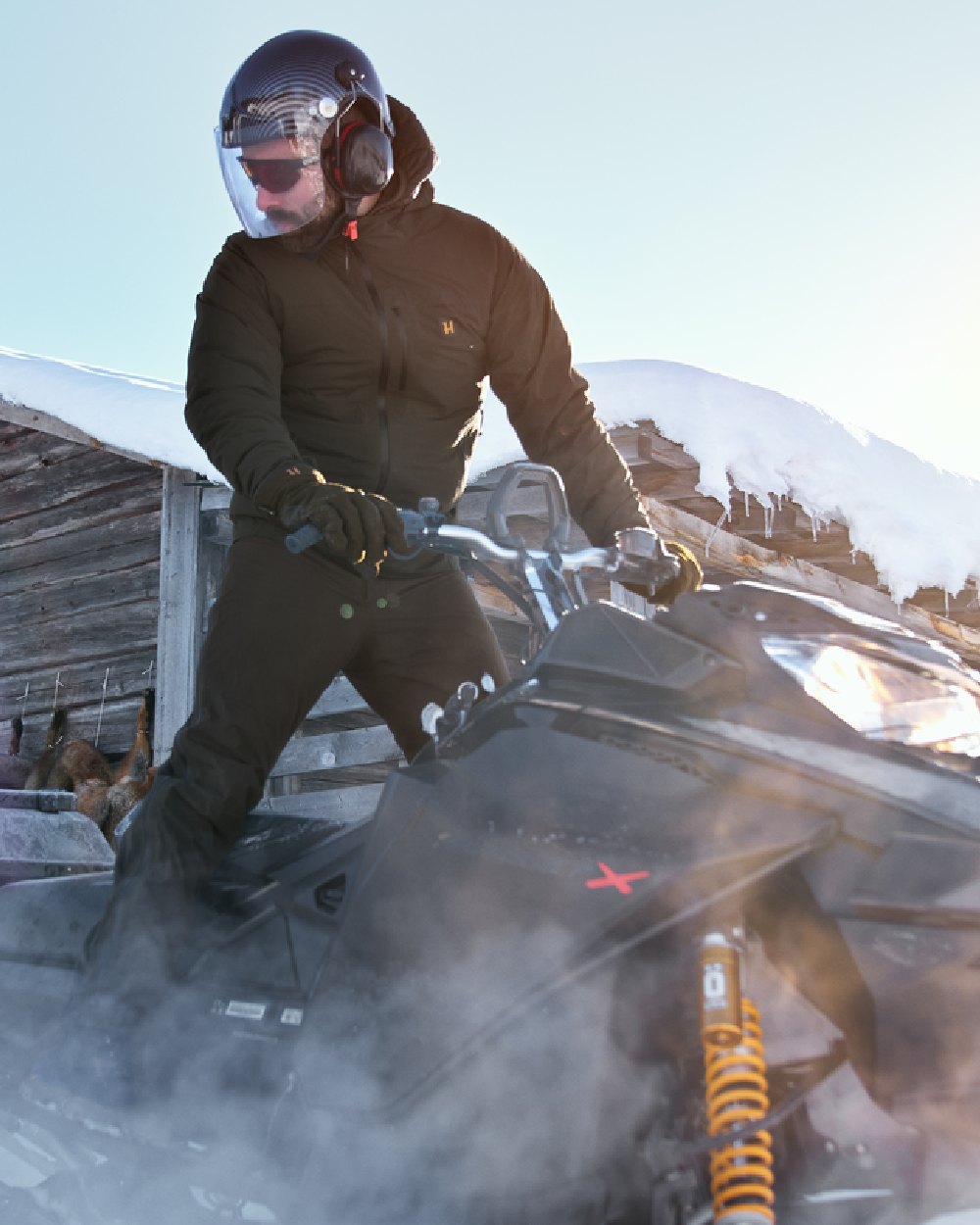 Willow Green Coloured Harkila Logmar HWS Packable Jacket on snow background 