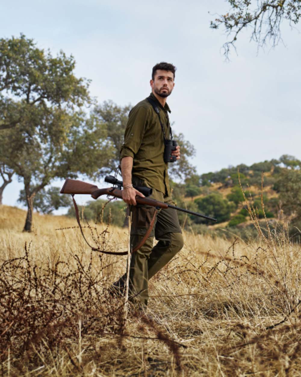 Dark Olive Willow Green Coloured Harkila Logmar Lightweight Zip Off Trousers on forest background 