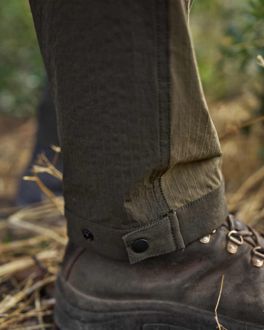 Dark Olive Willow Green Coloured Harkila Logmar Lightweight Zip Off Trousers on forest background 