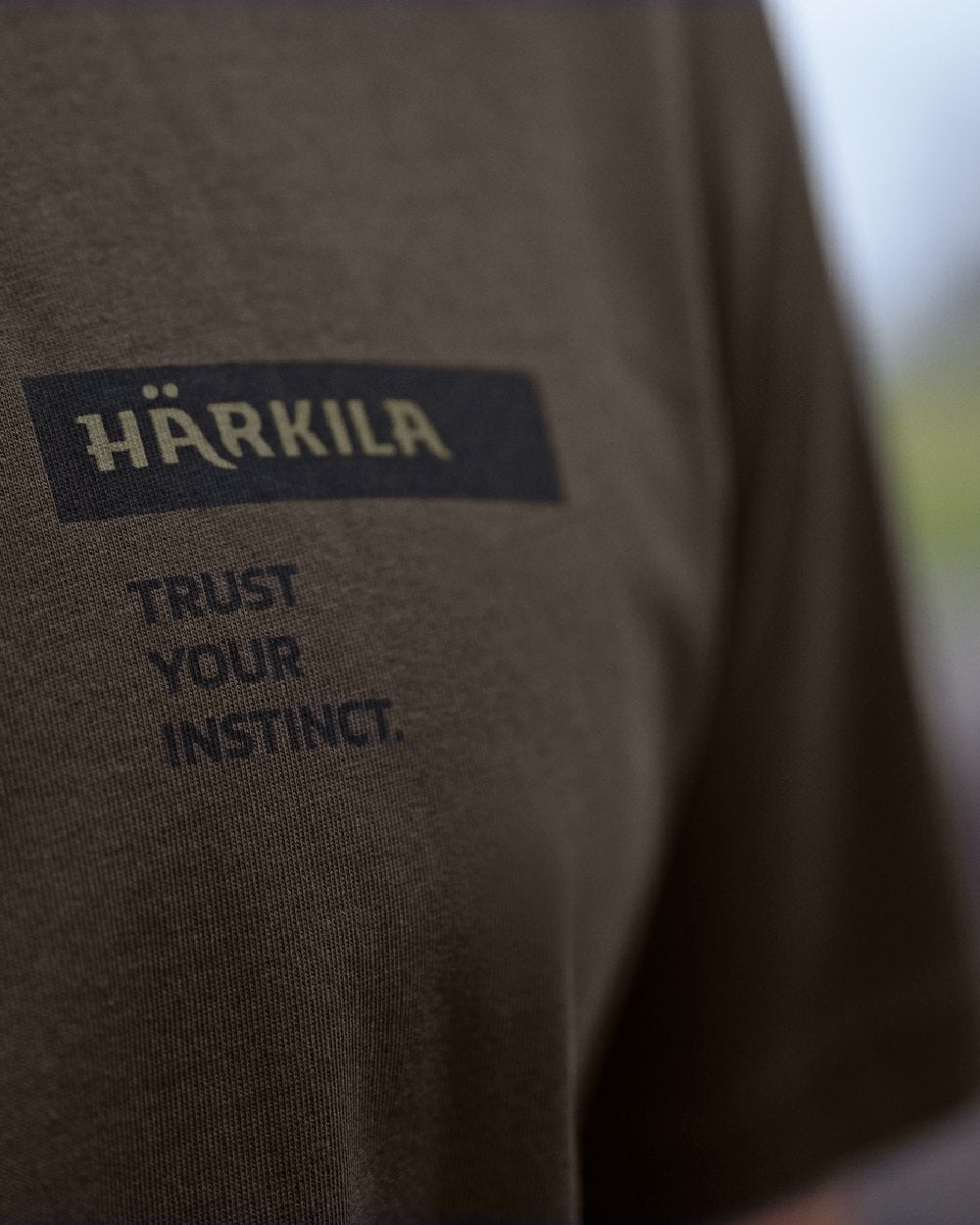 Shadow Brown/Tarmac coloured Harkila Logo Band Short Sleeve T-Shirt on outdoor background 