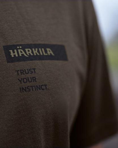 Shadow Brown/Tarmac coloured Harkila Logo Band Short Sleeve T-Shirt on outdoor background 