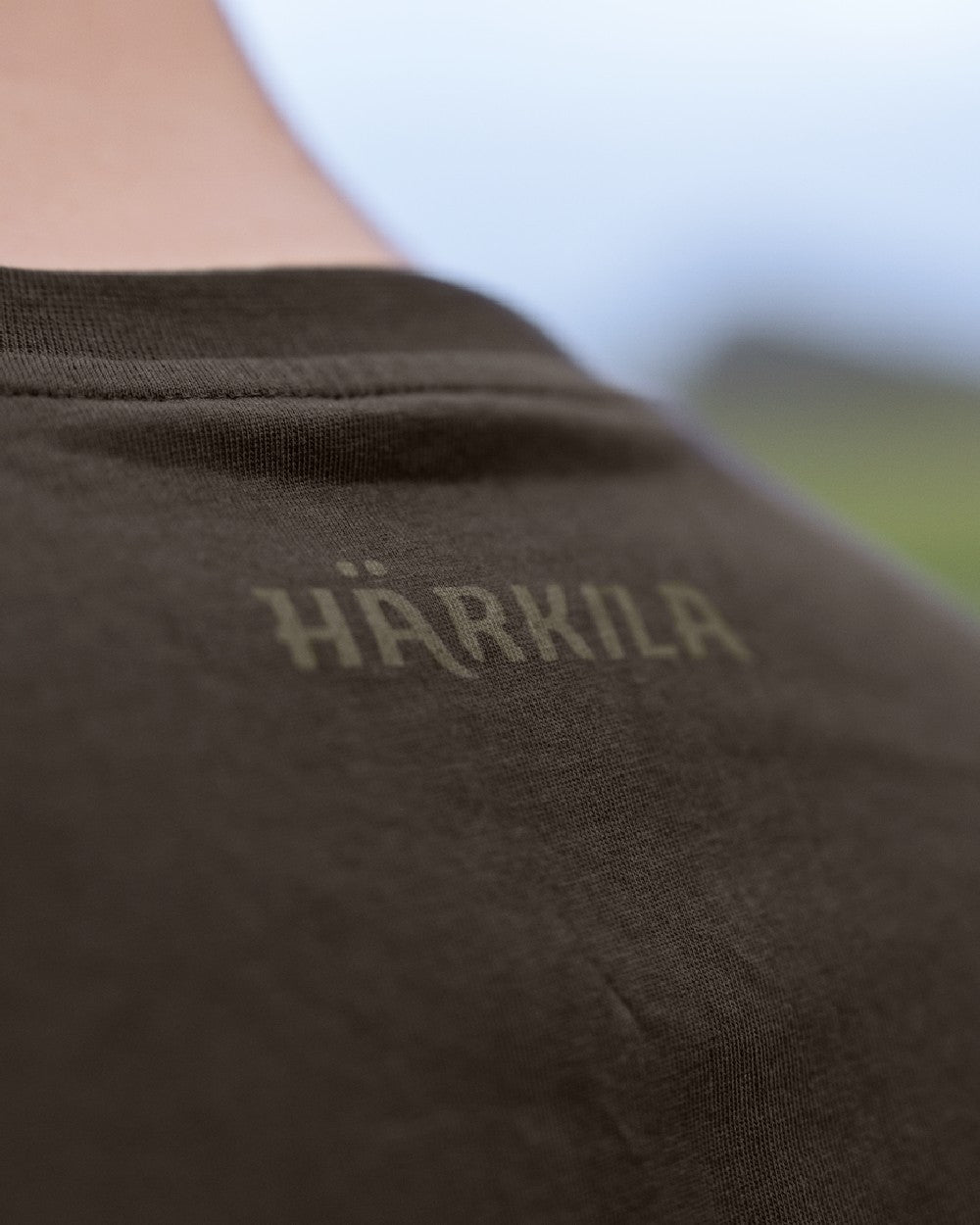 Shadow Brown/Tarmac coloured Harkila Logo Band Short Sleeve T-Shirt on outdoor background 