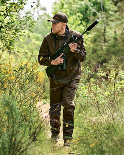 Willow Green coloured Harkila Mens Fjell Ace Trousers on forest background 