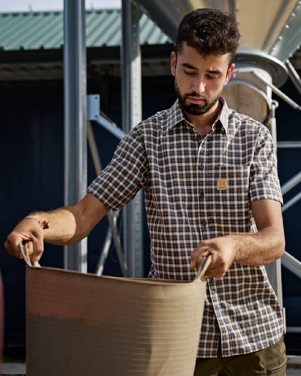 Naval Blue Check Coloured Harkila Mens Fjell Short Sleeve Shirt on construction background 