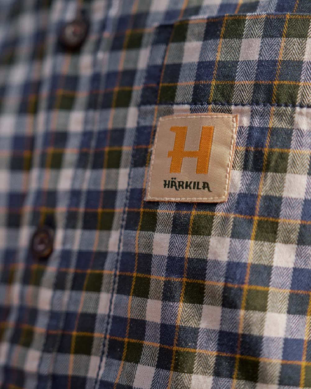 Naval Blue Check Coloured Harkila Mens Fjell Short Sleeve Shirt on blurry background 