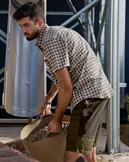 Dark Olive Willow Green Coloured Harkila Mens Fjell Shorts on outdoor background 