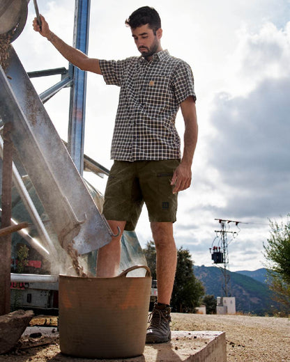 Dark Olive Willow Green Coloured Harkila Mens Fjell Shorts on outdoor background 