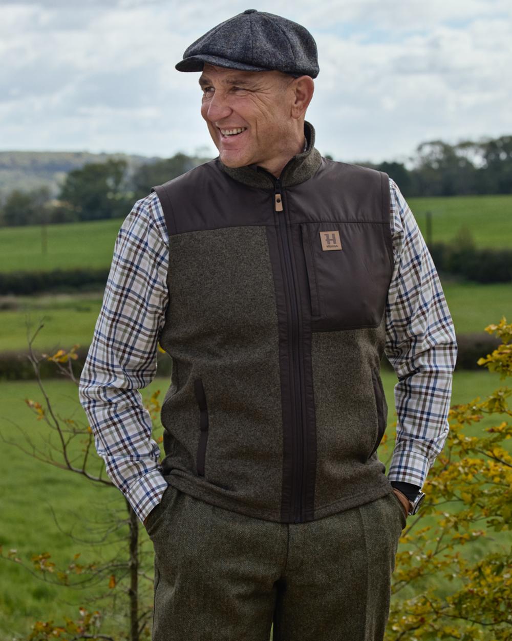 Willow Green Shadow Brown coloured Harkila Mens Kalix Fleece Waistcoat on outdoor background 