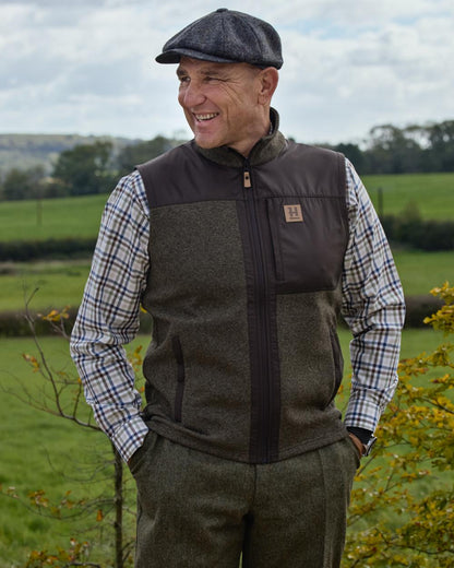 Willow Green Shadow Brown coloured Harkila Mens Kalix Fleece Waistcoat on outdoor background 