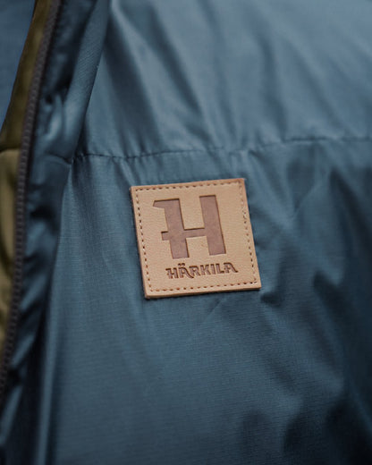 Willow Green Sea Blue Coloured Harkila Mens Kalix HSP Jacket on blurry background 