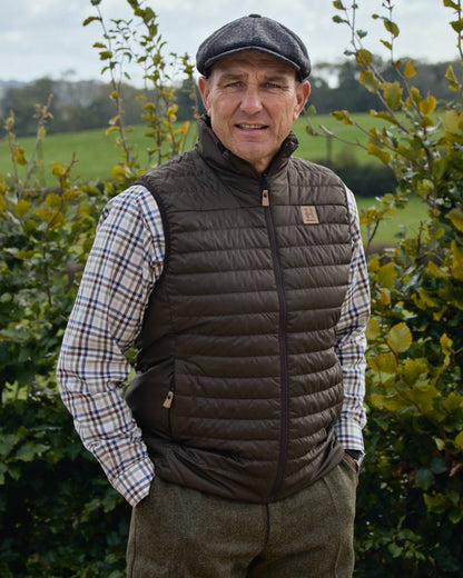 Willow Green Shadow Brown coloured Harkila Mens Kalix HSP Waistcoat on outdoor background 