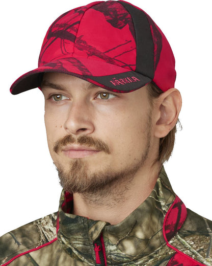 MossyOakRed coloured Harkila Moose Hunter 2.0 Safety Cap on white background 