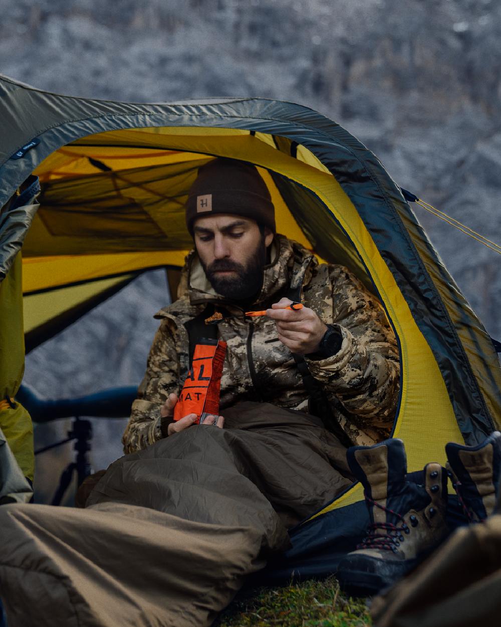 AXIS Mountain Coloured Harkila Mountain Hunter Expedition Packable Down Jacket on outdoor background 