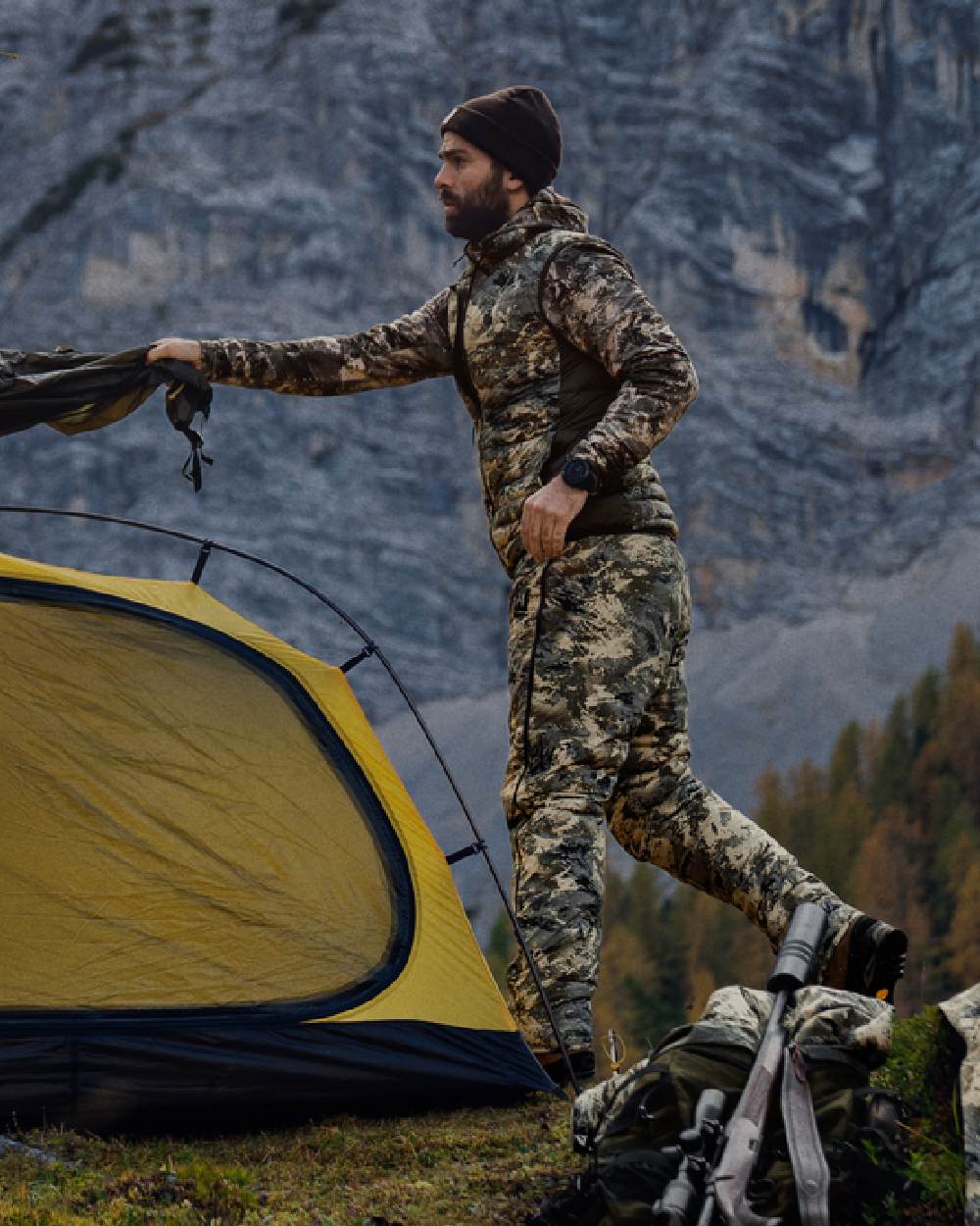 AXIS Mountain Shadow Brown Coloured Harkila Mountain Hunter Expedition Reversible Down Waistcoat on mountain background 