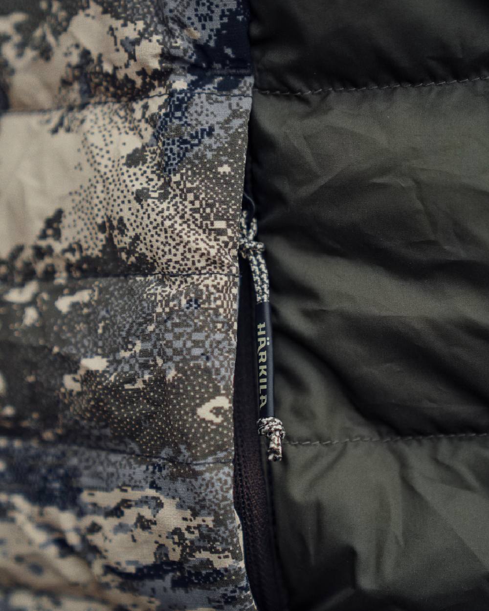 AXIS Mountain Shadow Brown Coloured Harkila Mountain Hunter Expedition Reversible Down Waistcoat on mountain background 