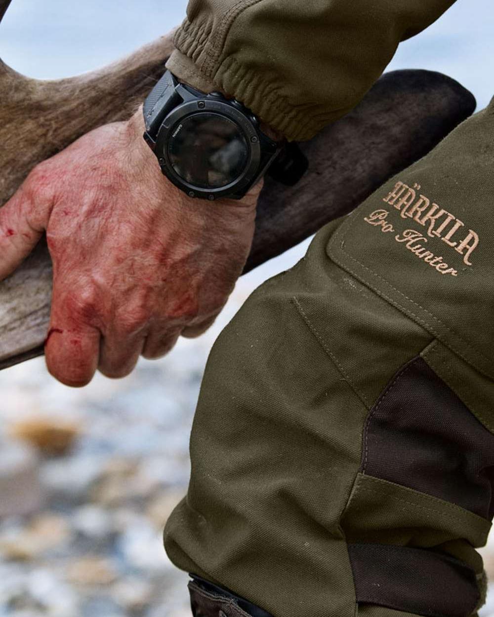 Willow Green Coloured Harkila Pro Hunter Endure Trousers on outdoor background 