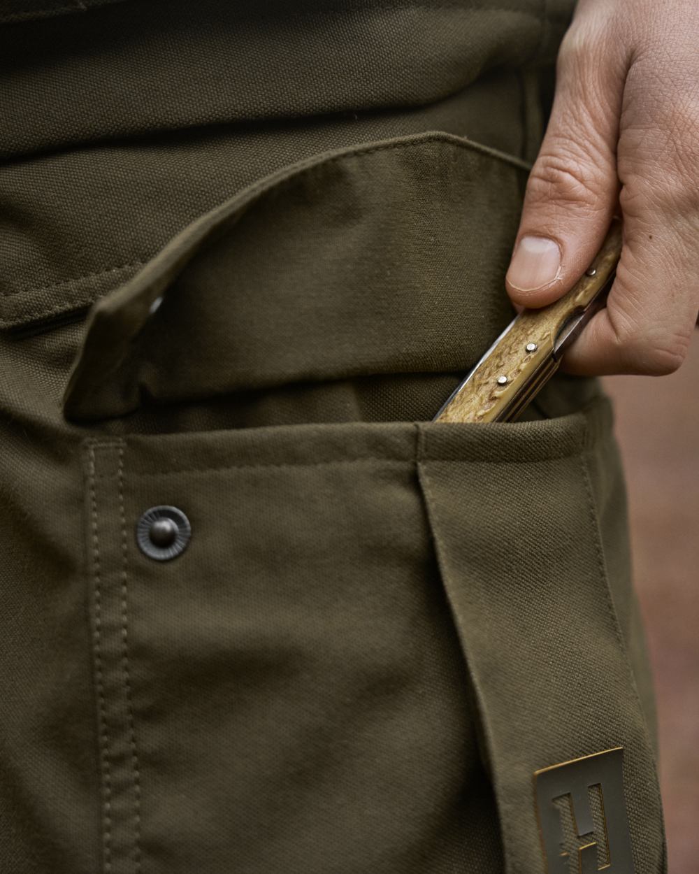 Willow Green Coloured Harkila Pro Hunter GTX Legacy Trousers on outdoor background 
