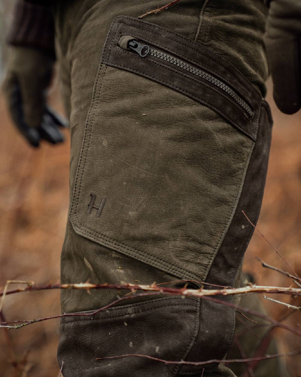 Willow Green Coloured Harkila Pro Hunter Leather Trousers on outdoor background 