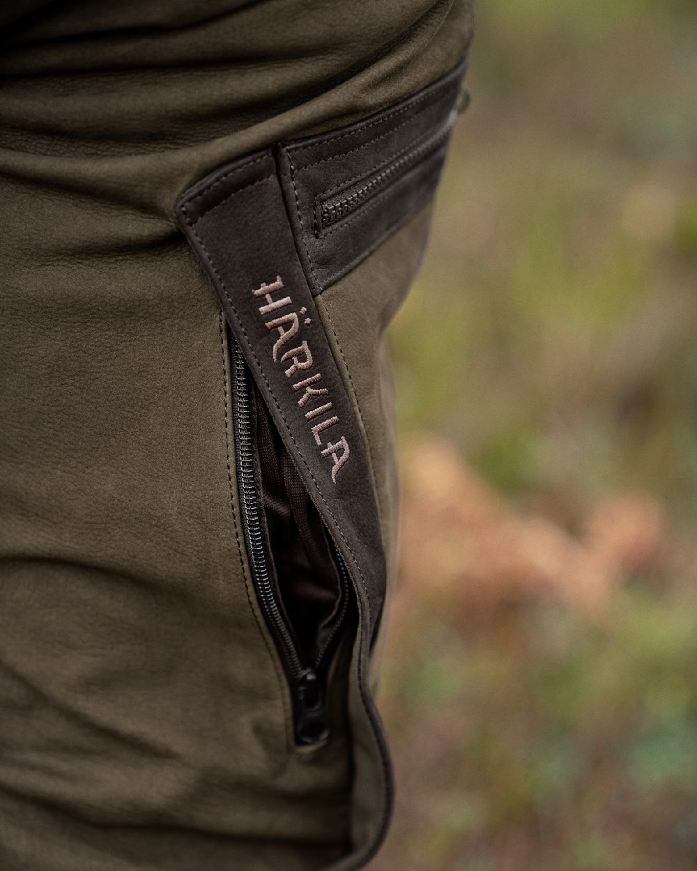 Willow Green Coloured Harkila Pro Hunter Leather Trousers on outdoor background 