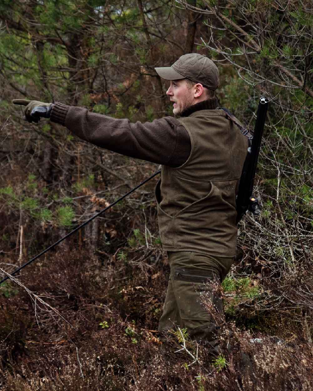 Willow Green Coloured Harkila Pro Hunter Leather Waistcoat on forest background 