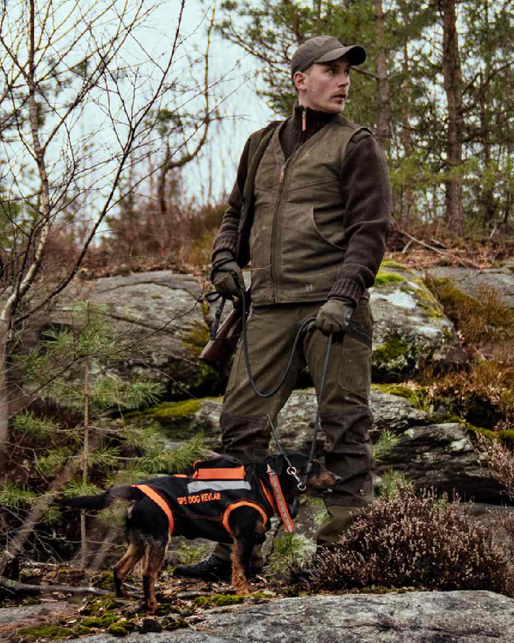 Willow Green Coloured Harkila Pro Hunter Leather Waistcoat on forest background 