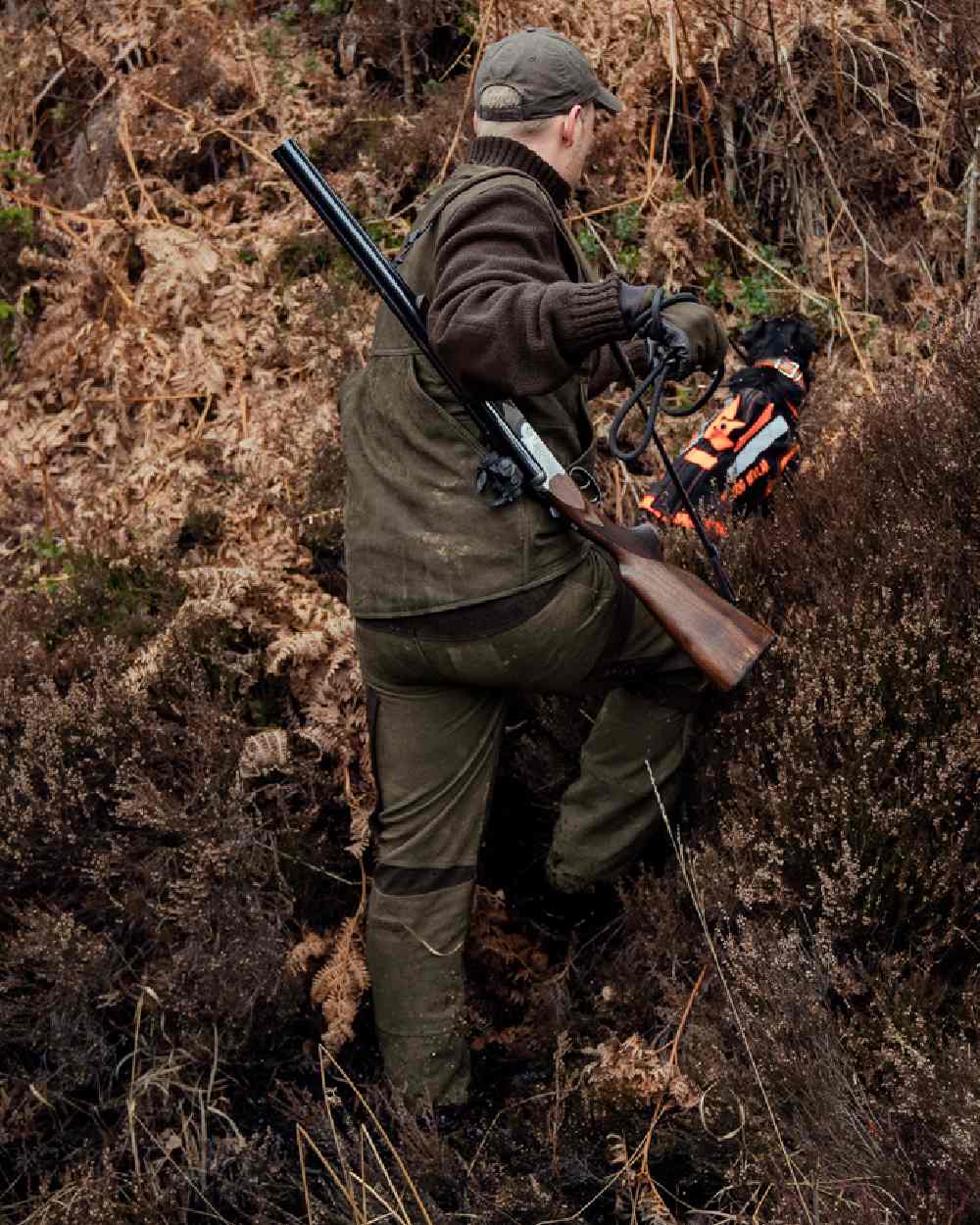 Willow Green Coloured Harkila Pro Hunter Leather Waistcoat on forest background 