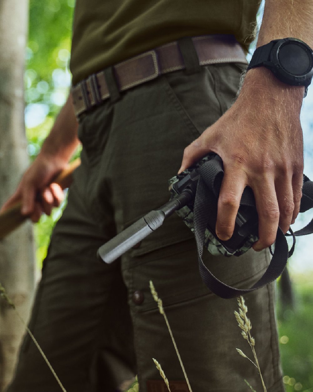 Light Willow Green Coloured Harkila Pro Hunter Light Trousers on forest background 