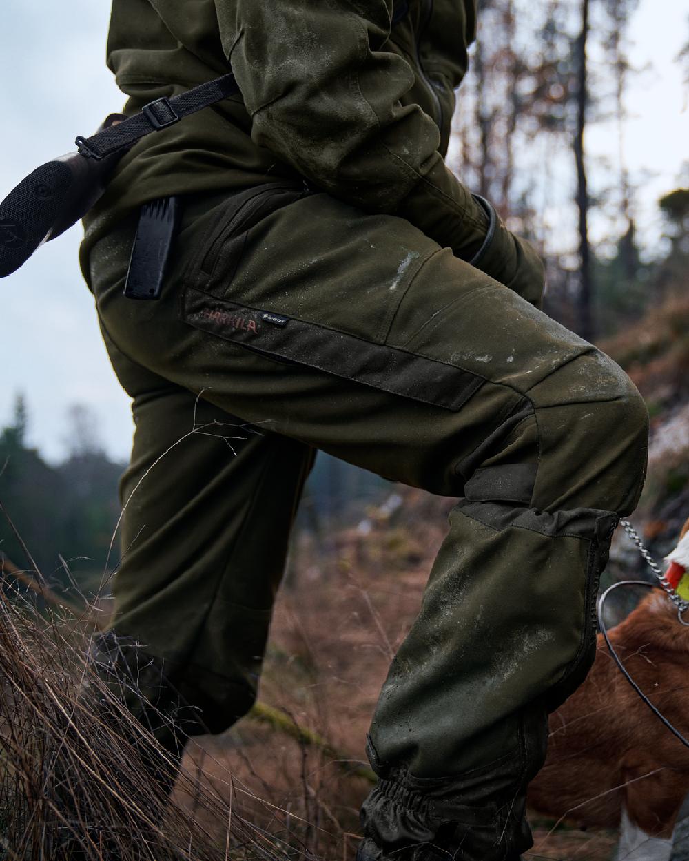 Willow Green Coloured Harkila Pro Hunter Move Trousers on outdoor background 