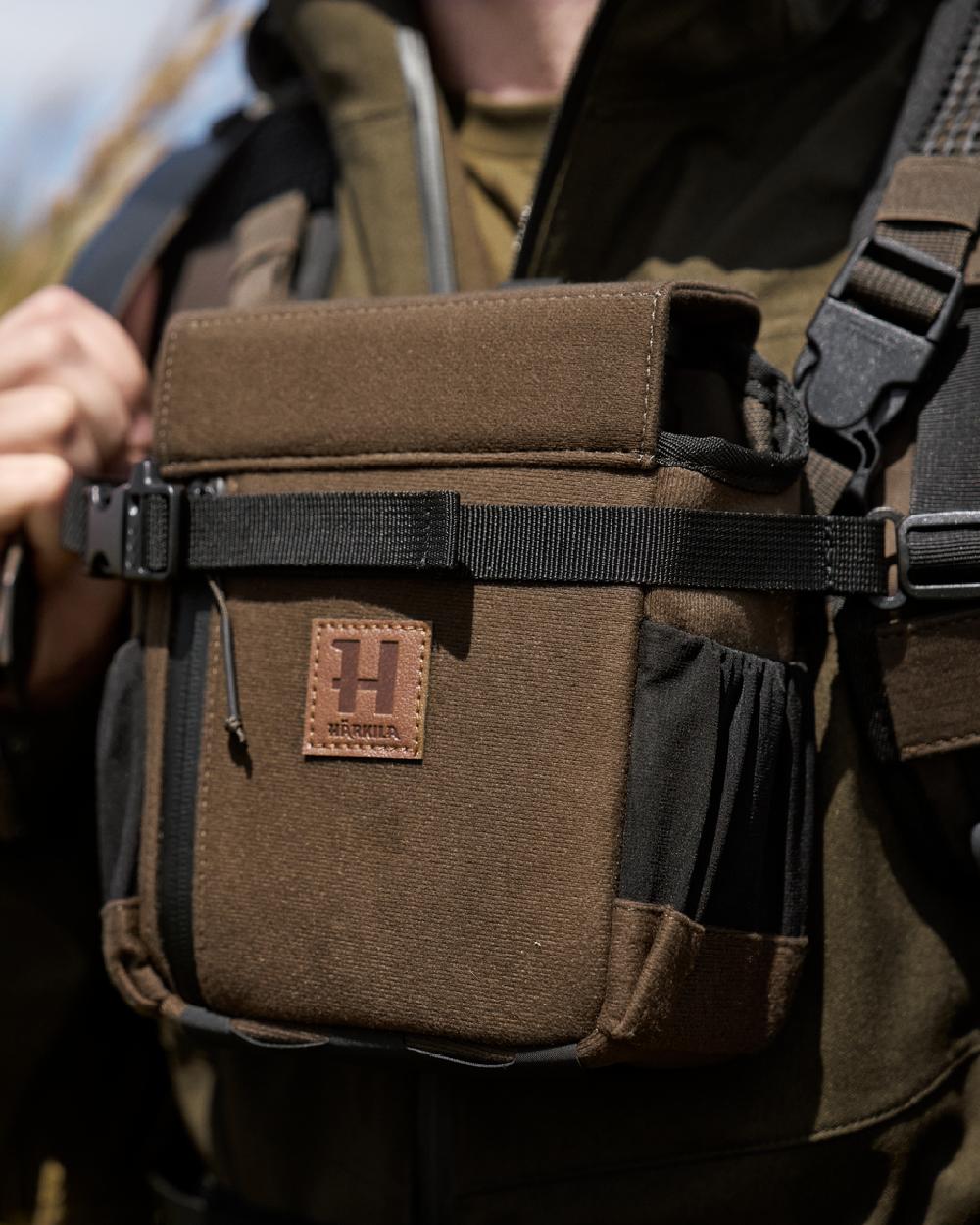 Willow Green Coloured Harkila Ragnar First Aid Backpack on blurry background 