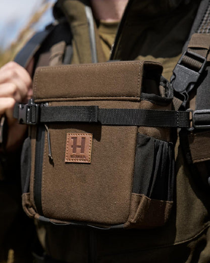 Willow Green Coloured Harkila Ragnar First Aid Backpack on blurry background 