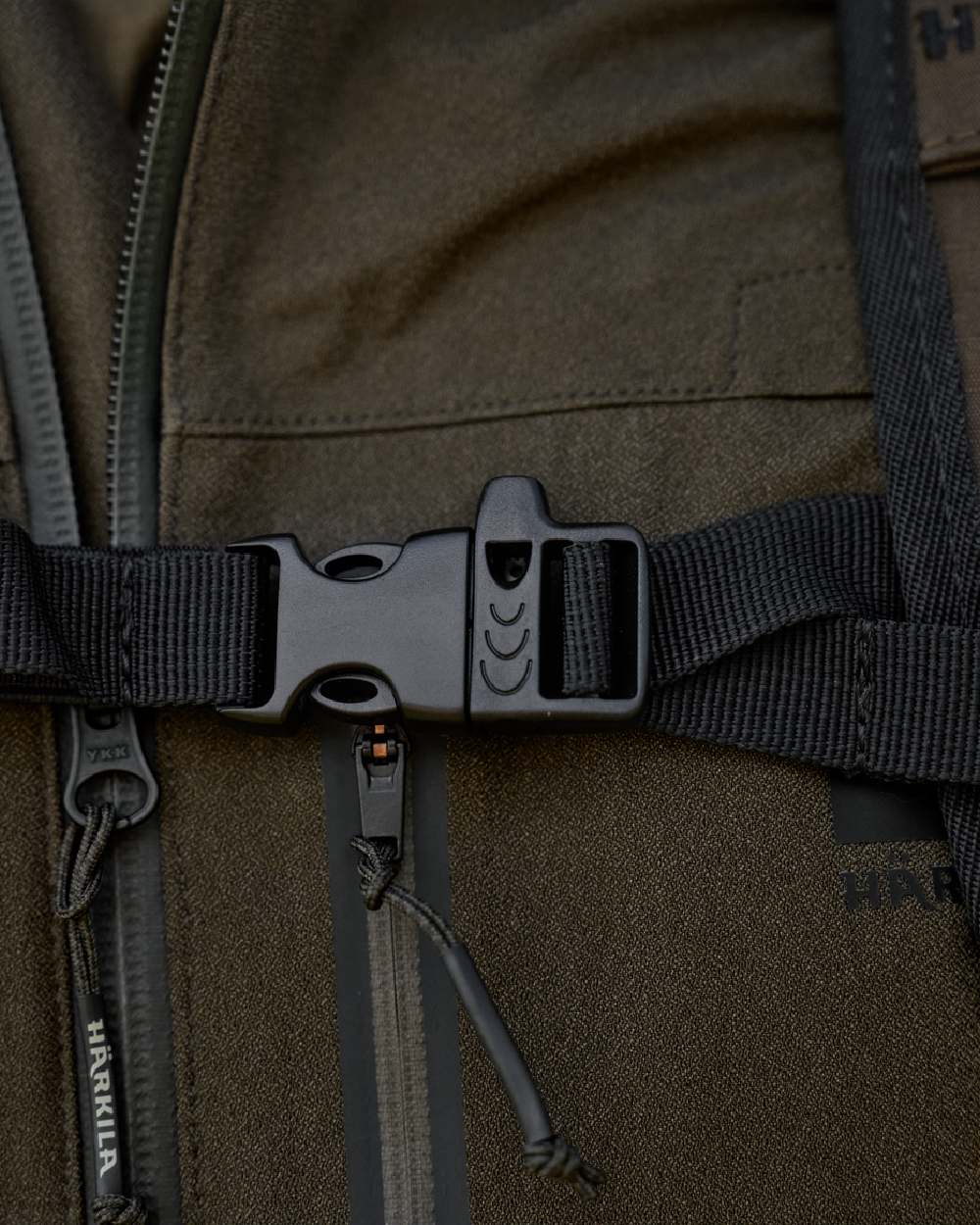 Willow Green Coloured Harkila Ragnar First Aid Backpack on blurry background 