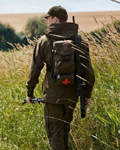 Willow Green Coloured Harkila Ragnar First Aid Backpack on forest background 