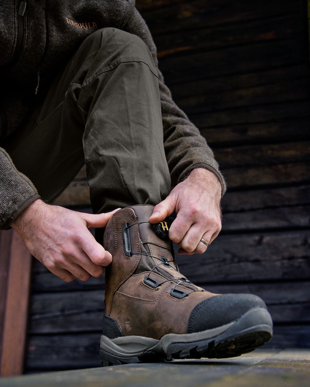 Dark Brown Coloured Harkila Reidmar Mid 2.0 GTX Leather Boots on outdoor background 