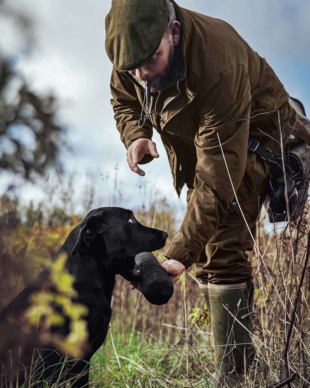 Warm Olive Coloured Harkila Retrieve Jacket on outdoor background 