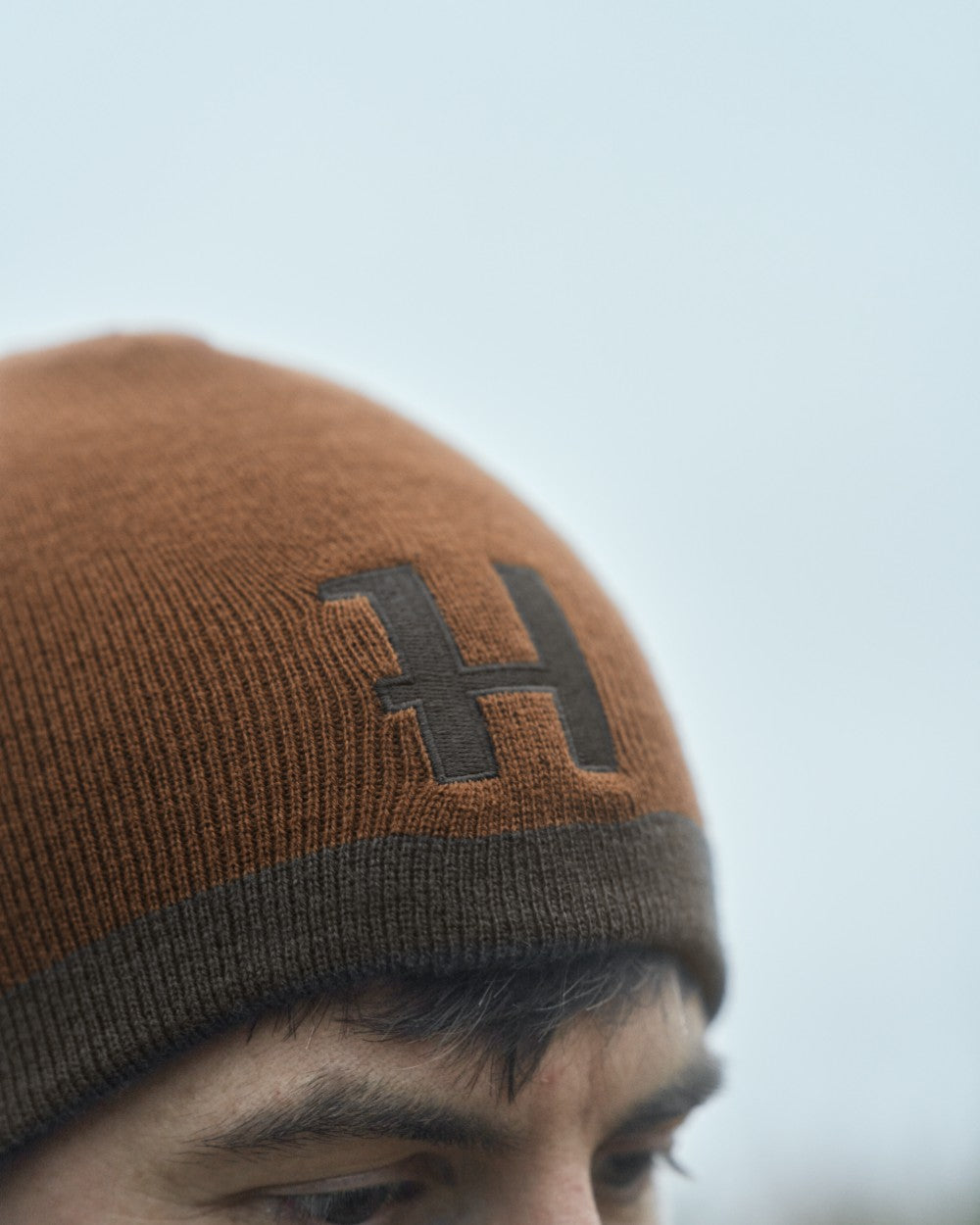 Shadow Brown Rustique Clay Coloured Harkila Reversible Beanie on outdoor background 