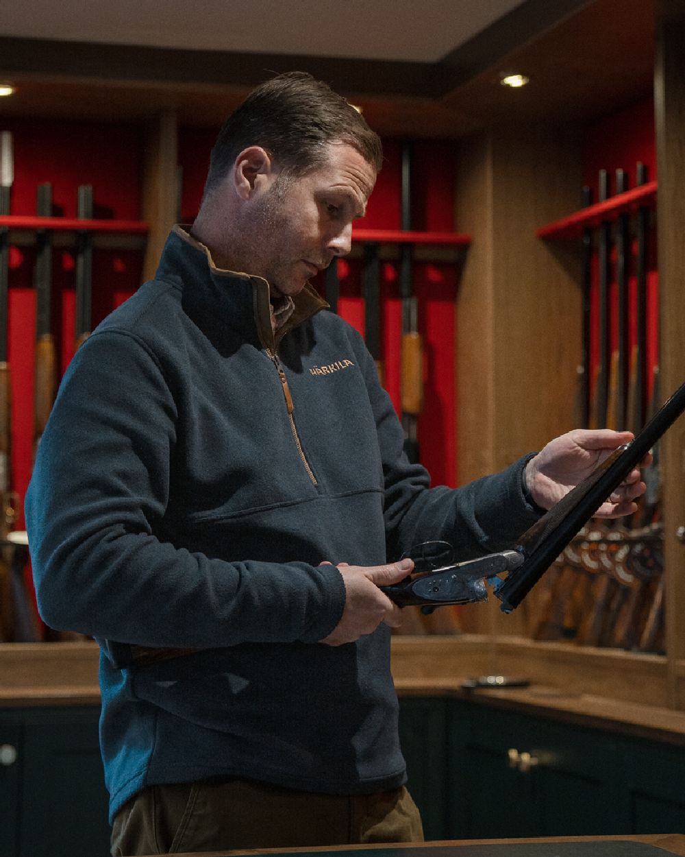 Dark Navy Coloured Harkila Sandhem 200 Fleece Pullover on indoor background 
