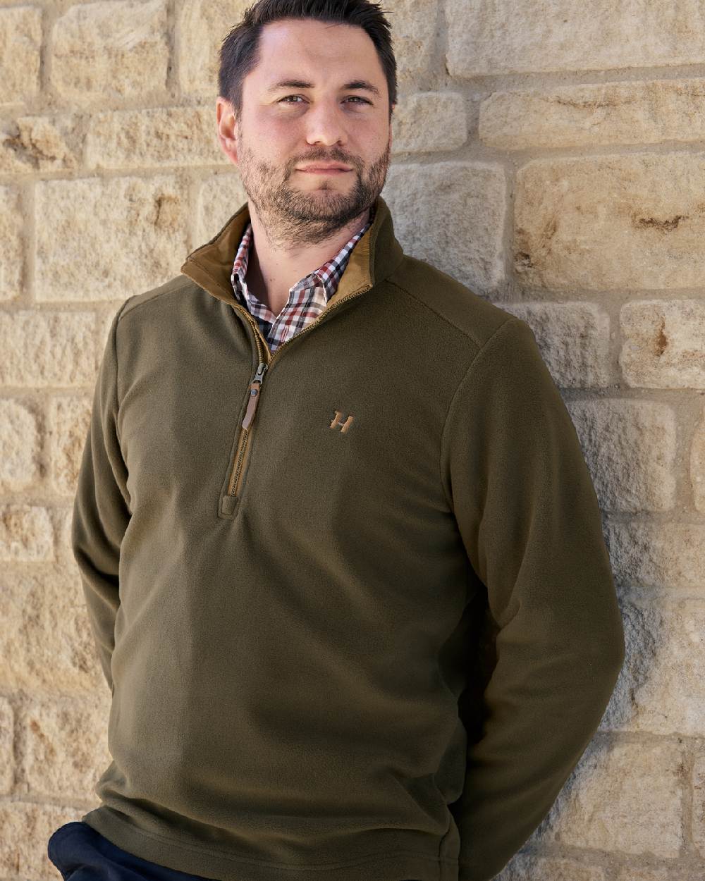 Willow Green Coloured Harkila Sandhem 200 Fleece Pullover on wall background 