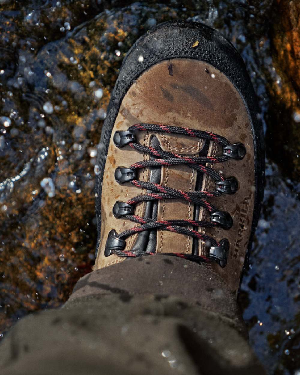 Mid Brown Coloured Harkila Saxnas GTX Boots on water background 