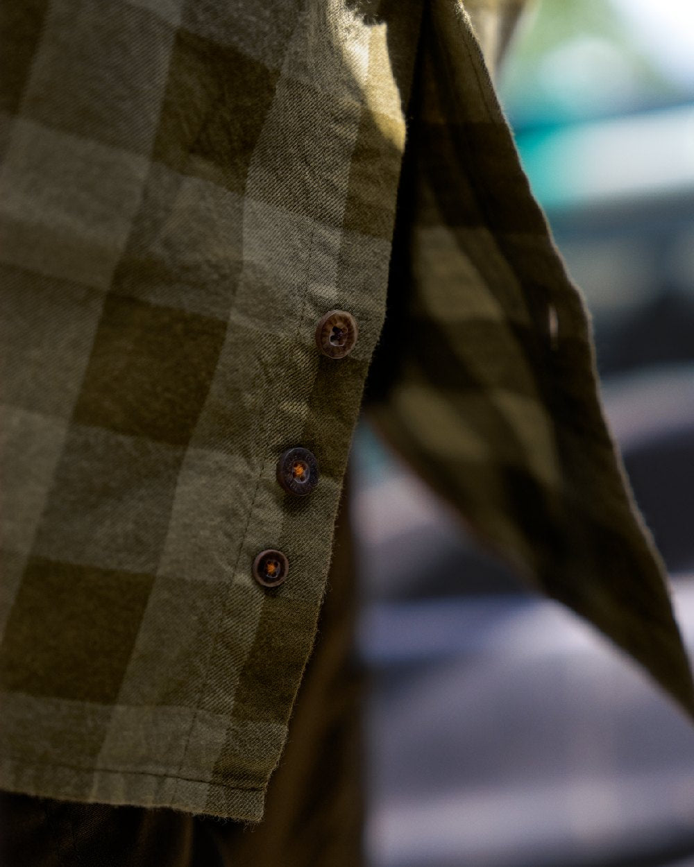 Dark Olive Check Coloured Harkila Scandinavian Long Sleeve Shirt on blurry background 