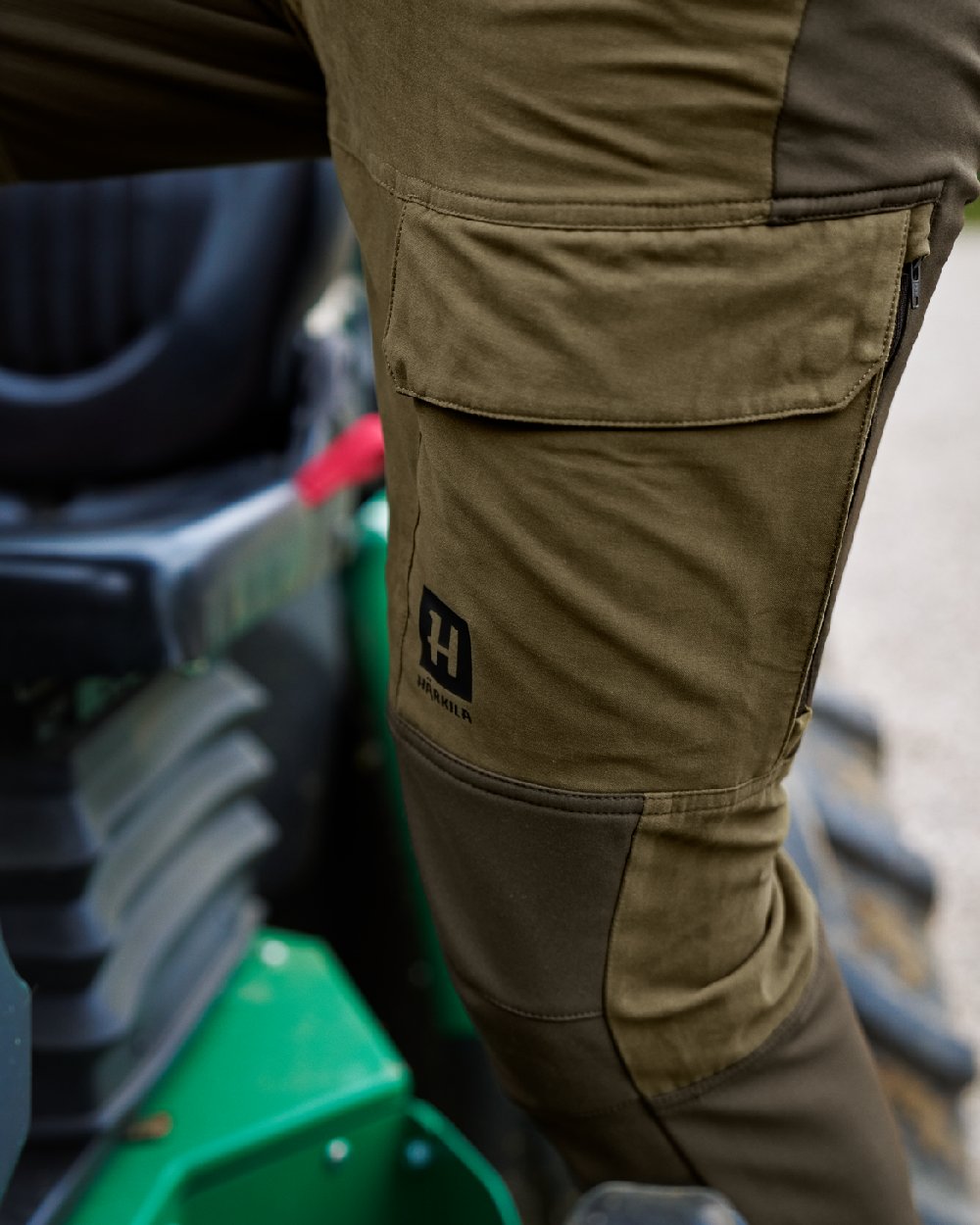 Dark Olive Willow Green Coloured Harkila Scandinavian Trousers on outdoor background 