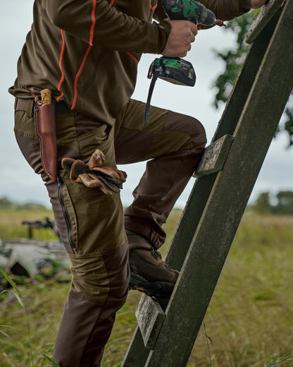 Willow Green Deep Brown Coloured Harkila Scandinavian Trousers on forest background 