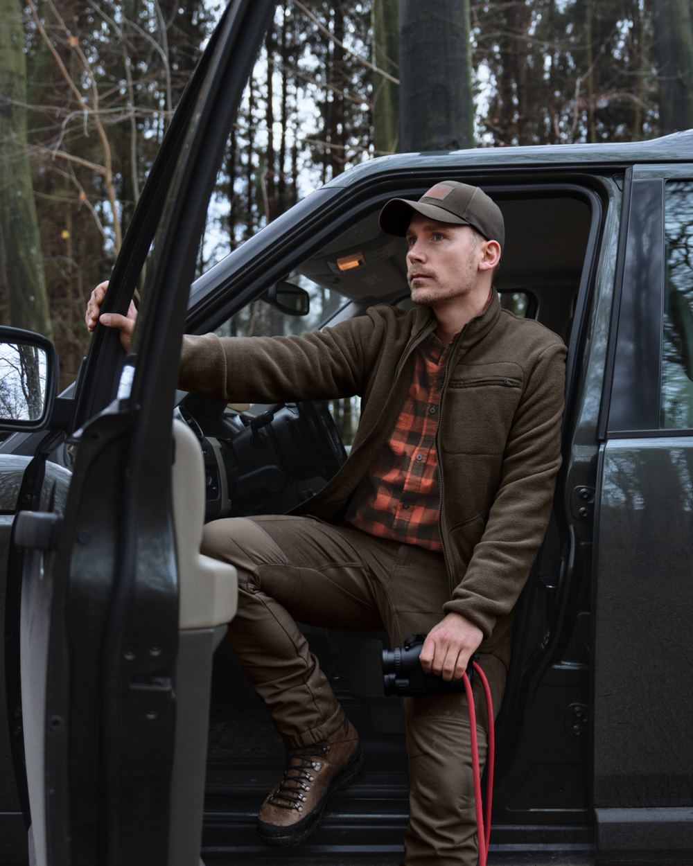 Dark Brown coloured Harkila Torsby Fleece Jacket on outdoor background 