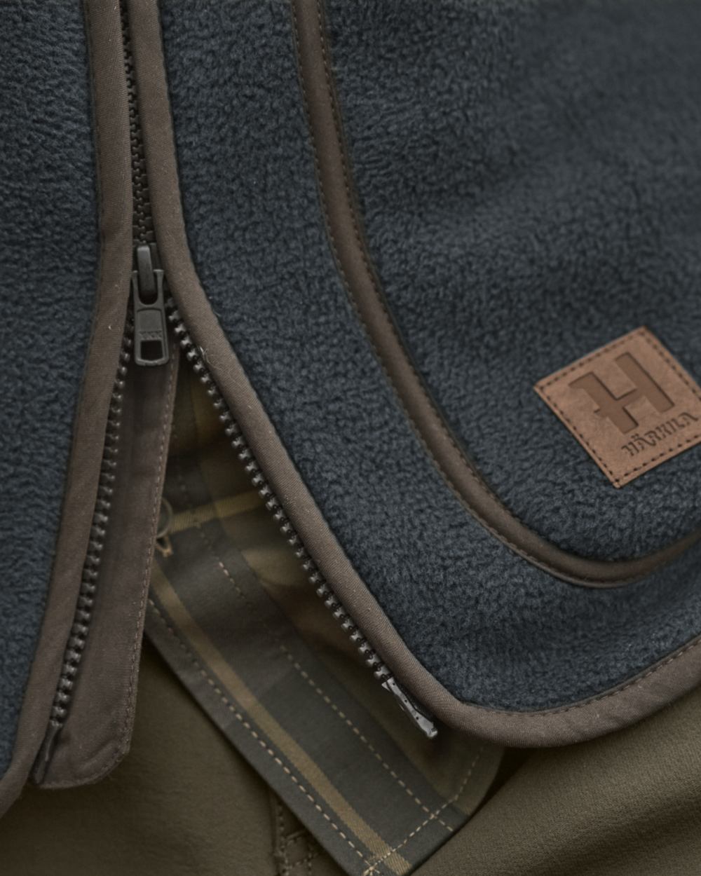 Dark Navy Coloured Harkila Torsby Fleece Jacket on outdoor background 